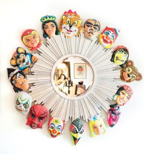 Vintage Halloween masks from the 1960s and 70s attached to a starburst mirror