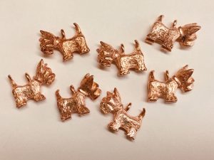 These tiny copper Scottie dog charms can go on a necklace or bracelet.