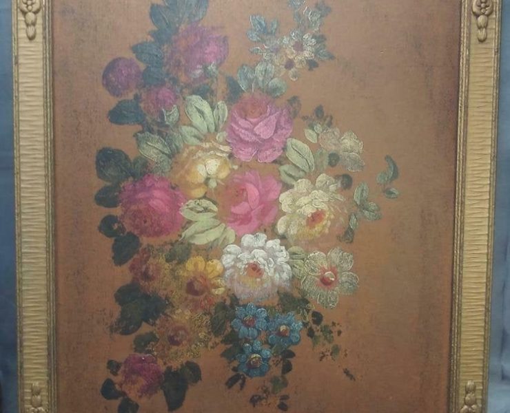 Bushel of antique flowers and leaves in the middle of a bronze-colored background with an ornate gold frame.