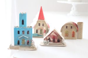 Group of four putz houses in a variety of house styles.