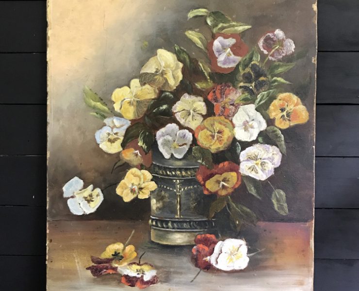 Mostly neutral scale painting of white, yellow and red pansies in an antique silver vase with some flowers on the table below.