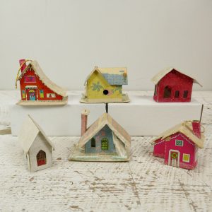 Group of six putz houses with some tropical details and bright colors like red and yellow.
