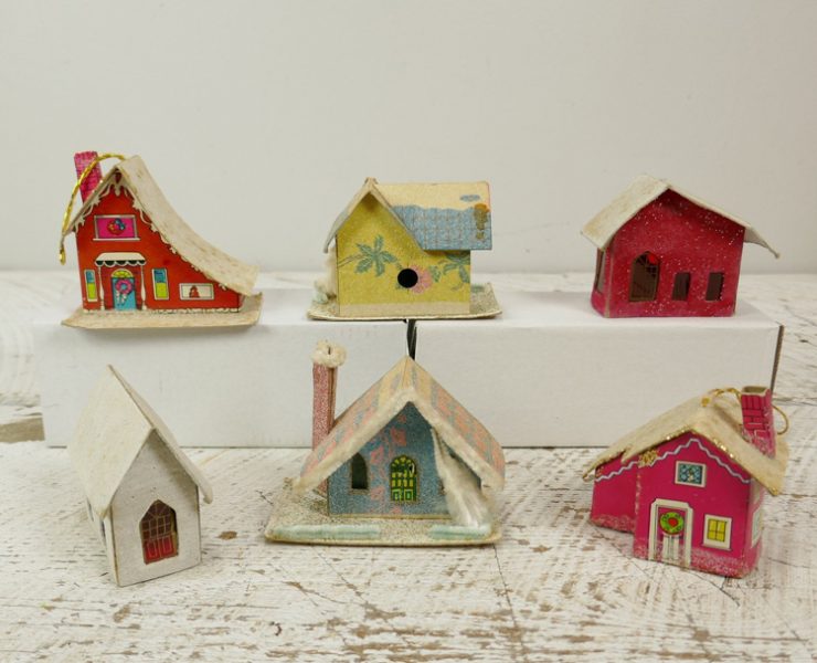 Group of six putz houses with some tropical details and bright colors like red and yellow.