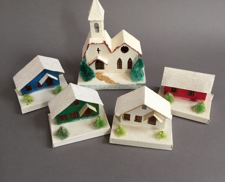 Group of five putz houses with snow covered rooftops and different colors.