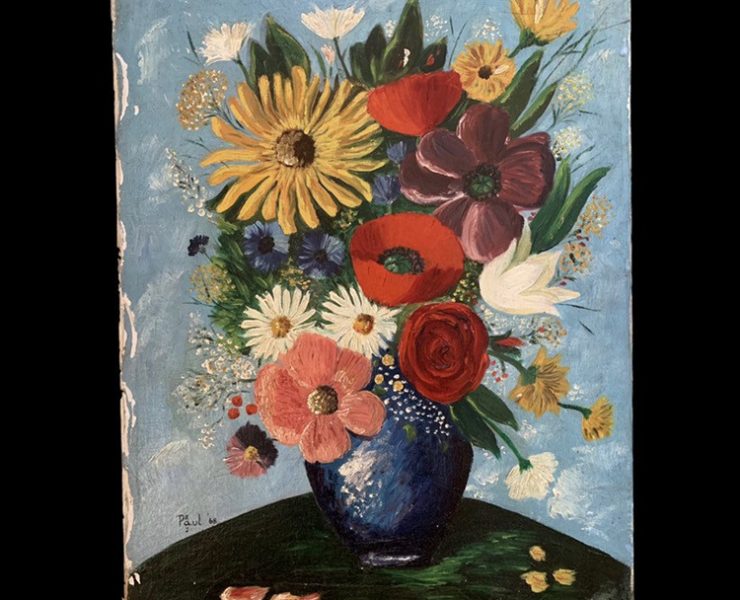 Colorful flowers in a dark blue vase with a sky blue background.