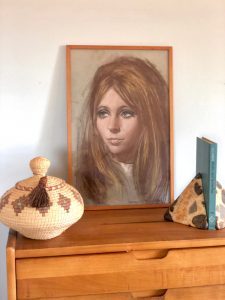 This vintage portrait shows a girl with straight, volumized blonde hair and dark smoky eyes.