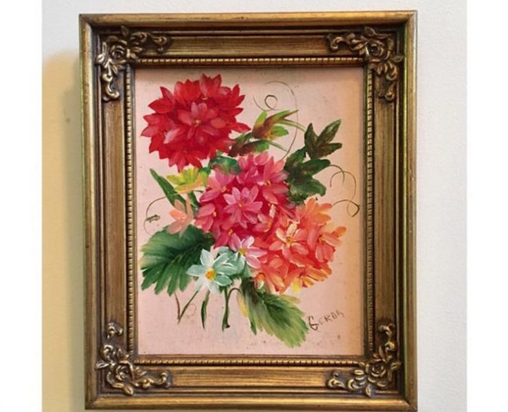 Small, ornate, gold frame with leafy pink flowers and a light pink background.