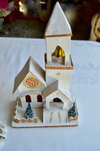 White chapel putz house that lights up and has a metal gold bell in the steeple.