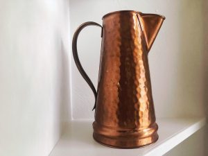 Hammered copper pitcher.