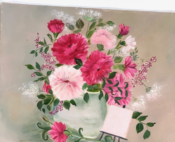 Pale green vase with many pink flowers with a beige background.