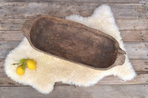 Rustic, hand-carved wooden bowl that's roughly hewn.
