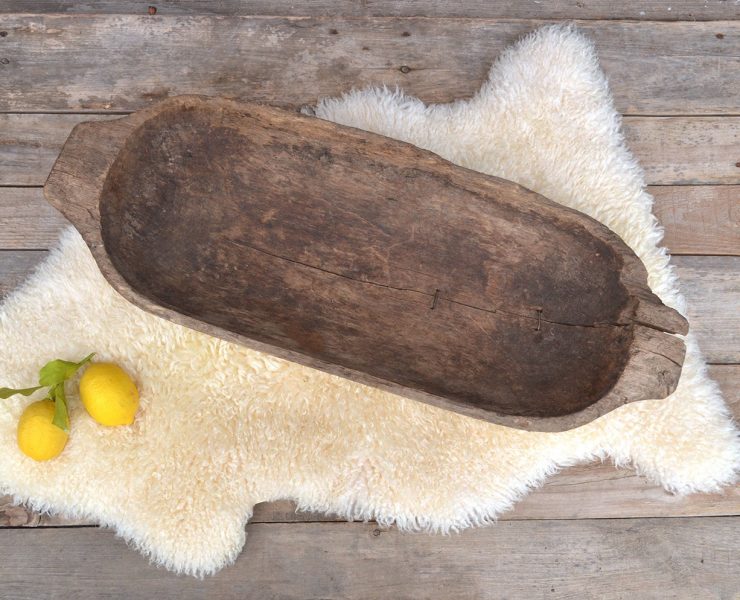 Rustic, hand-carved wooden bowl that's roughly hewn.