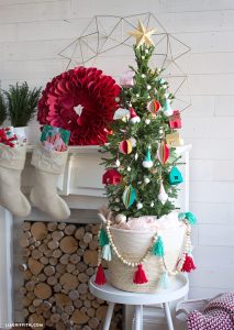 Christmas tree stands fashioned out of a woven basket and unique red and blue tassels.