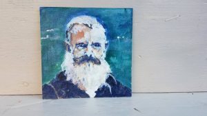 This vintage portrait is of an elderly man with a white beard and gray mustache, surrounding by a blue and teal background.