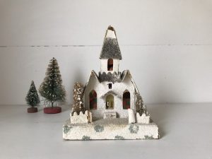 White chapel model with a gray, snowy roof and front yard.