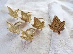 Brass napkin rings in the shape of leaves.