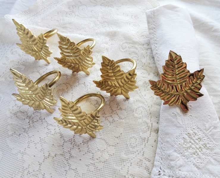 Brass napkin rings in the shape of leaves.
