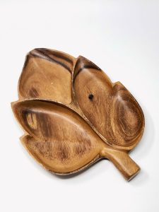 Wood tray with four sections in the shape of a leaf.