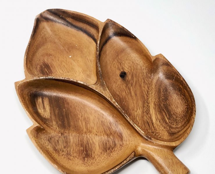 Wood tray with four sections in the shape of a leaf.