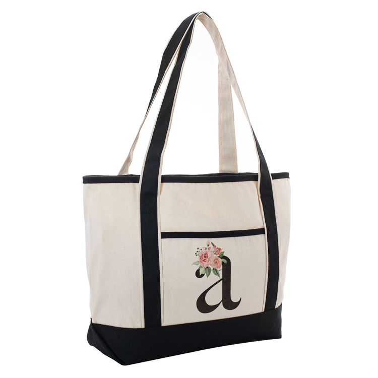 This canvas bag is off-white with black straps and one outside pocket for extra storage, which has a personalized floral letter decal attached.