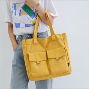 This yellow canvas bag is perfect for the flea market because of its thick straps and two outer pockets with flaps for extra storage.
