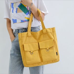 This yellow canvas bag is perfect for the flea market because of its thick straps and two outer pockets with flaps for extra storage.
