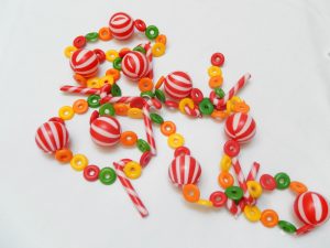 Vintage garland made out of plastic beads shaped like peppermints, candy canes and fruit loop cereal pieces.