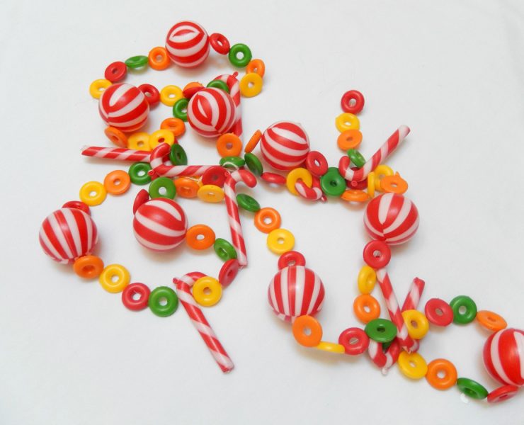 Vintage garland made out of plastic beads shaped like peppermints, candy canes and fruit loop cereal pieces.
