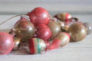Vintage garland with worn gold, red and green colored glass beads.