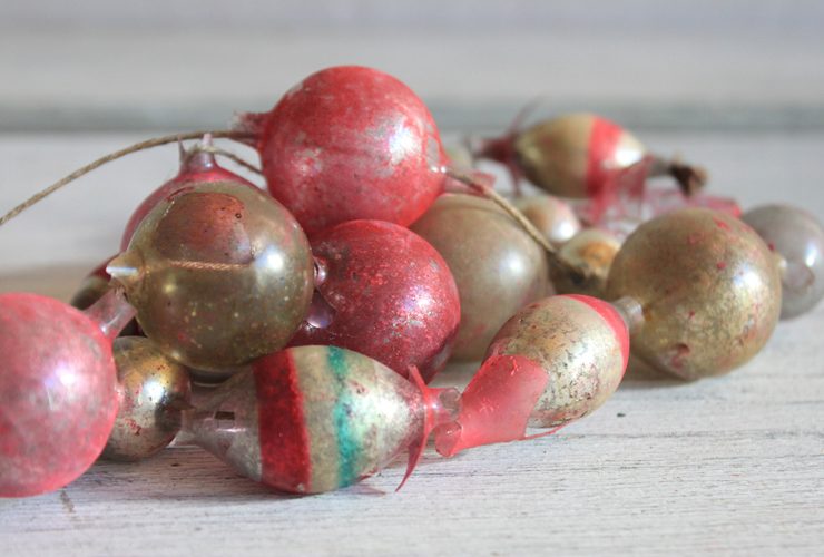 Vintage garland with worn gold, red and green colored glass beads.