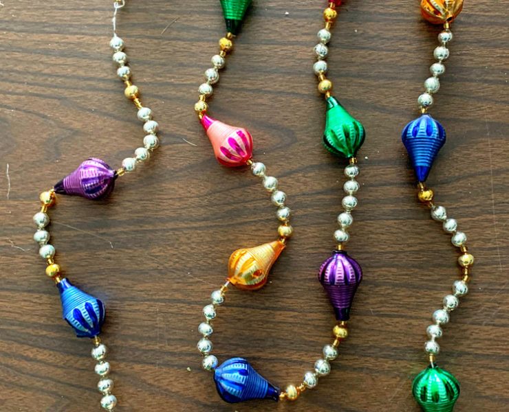 Vintage garland with white and gold beads between large, colorful, teardrop-shaped glass beads.