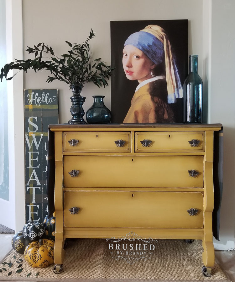 Yellow dresser with metal bumblebee handles.