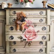Off-white and floral dresser with a puppy resting in an open drawer.