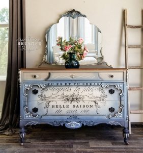 Bureau with blue and white blended paintwork and cursive print on the front.