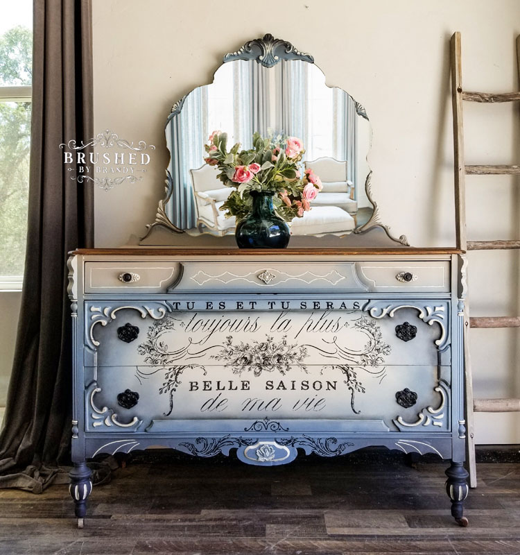 Bureau with blue and white blended paintwork and cursive print on the front.