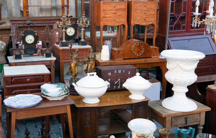 A collection of white, antique ceramics complemented with vintage wood furniture.