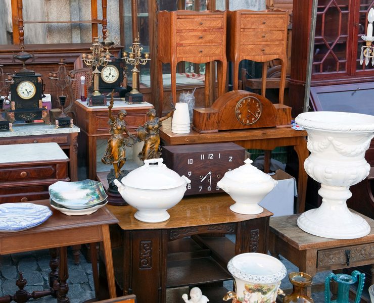 A collection of white, antique ceramics complemented with vintage wood furniture.