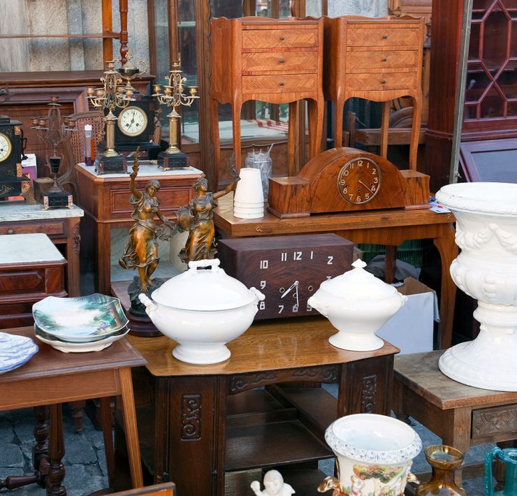 A collection of white, antique ceramics complemented with vintage wood furniture.