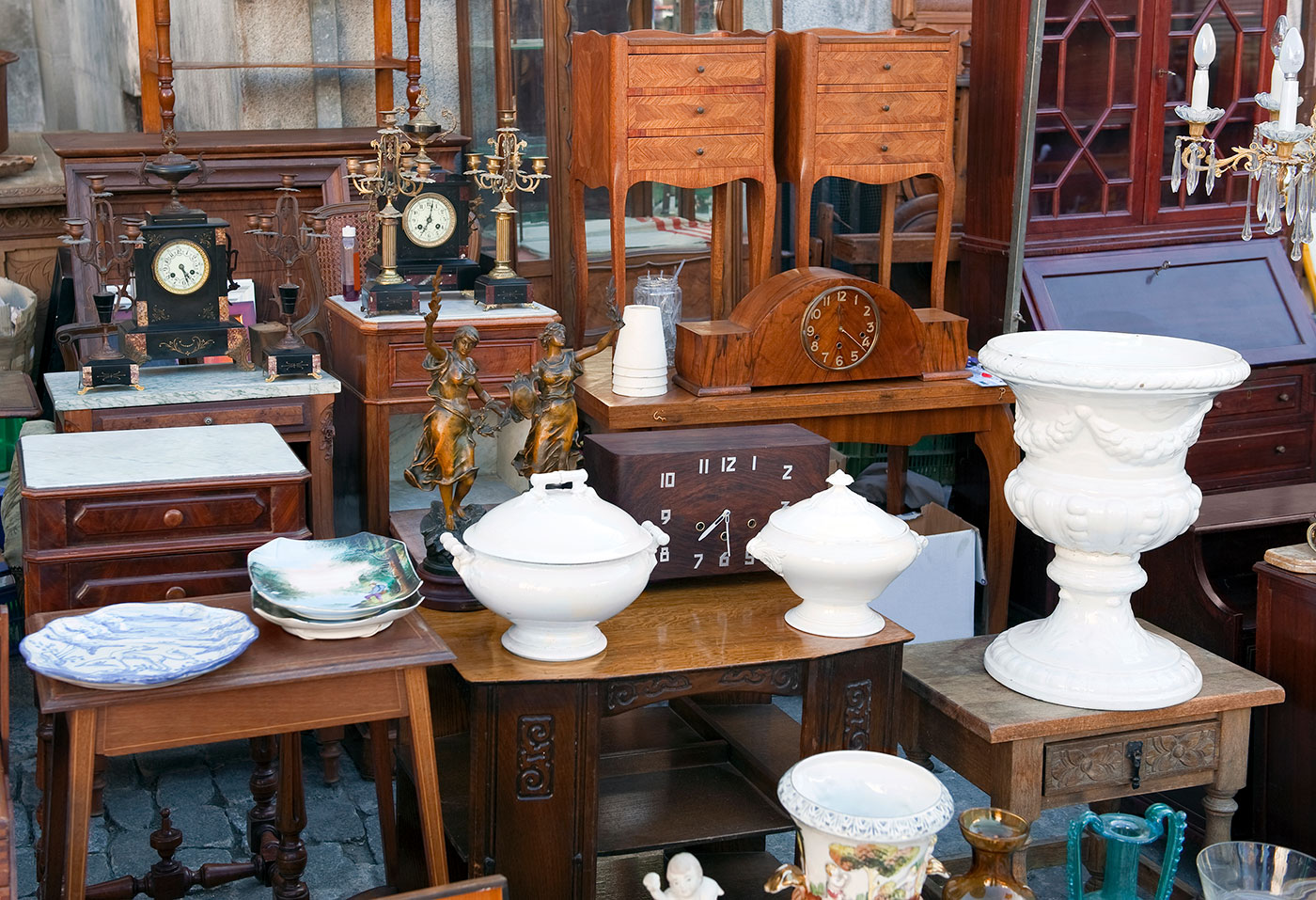 A collection of white, antique ceramics complemented with vintage wood furniture.