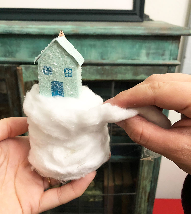 Homemade glitter house on a snowy hill of cotton balls
