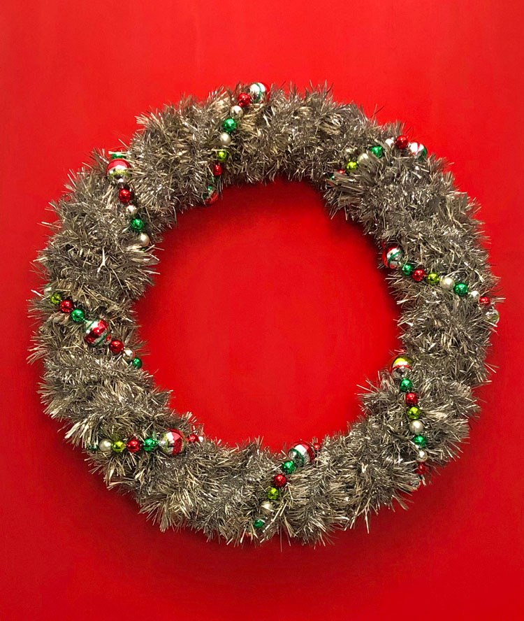 vintage wreath decorated for Christmas with Shiny Brite garland