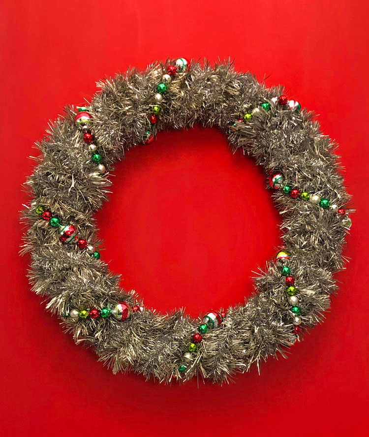 vintage wreath decorated for Christmas with Shiny Brite garland