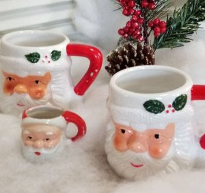 Three Santa mugs, two the same size and one mini one.