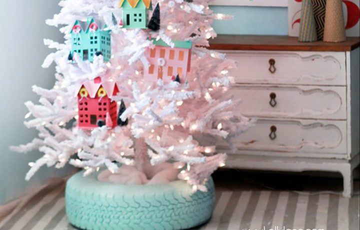 A Christmas tree stand cover in the shape of a turquoise-painted tire.