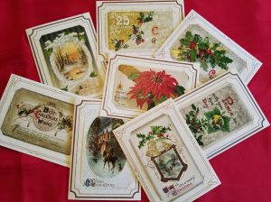 Antique holiday postcards with varying Christmas designs and text on them.