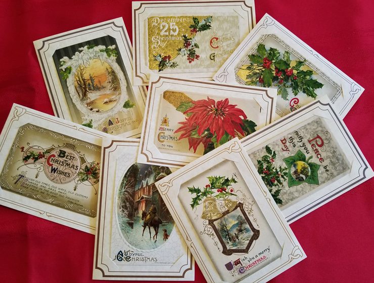 Antique holiday postcards with varying Christmas designs and text on them.