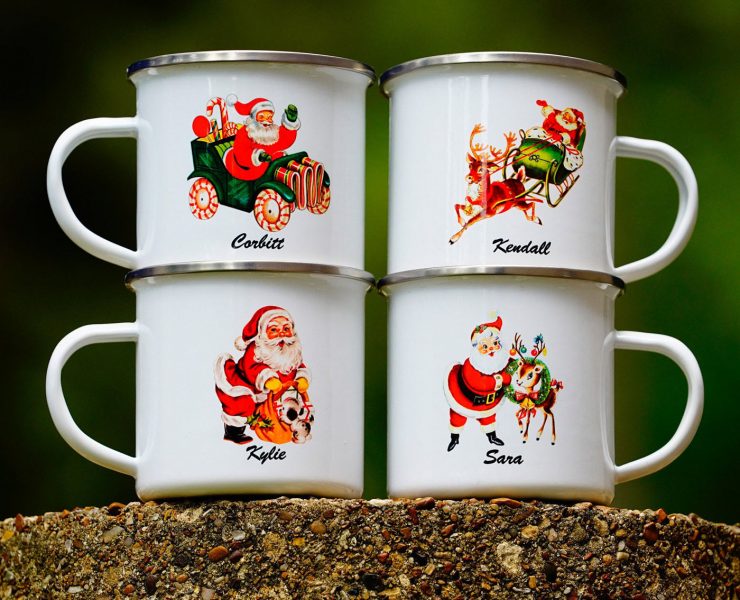 Metal Santa mugs with different vintage-inspired illustrations of Santa and personalized names on them.