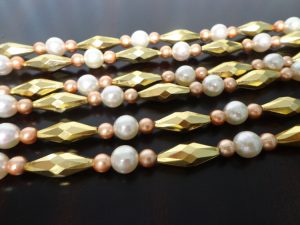 Vintage garlands made out of gold and pearl plastic beads.