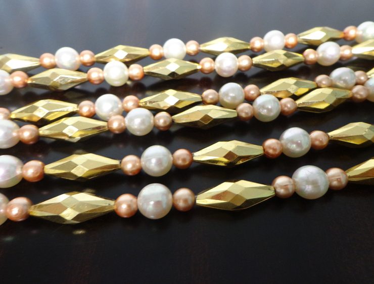 Vintage garlands made out of gold and pearl plastic beads.