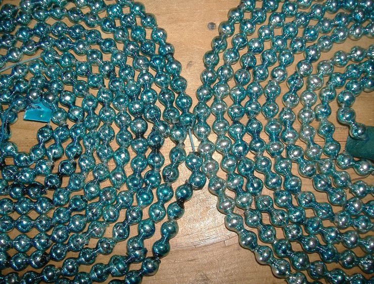 Vintage garlands made out of teal blue mercury beads.